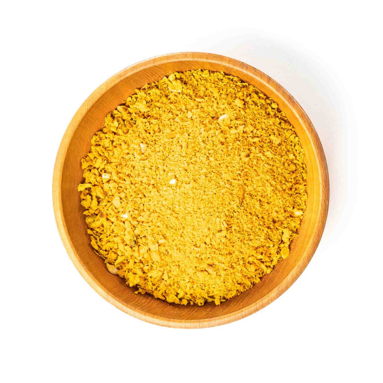 Wooden bowl filled with green juju freeze dried golden blend with bee pollen on a white background