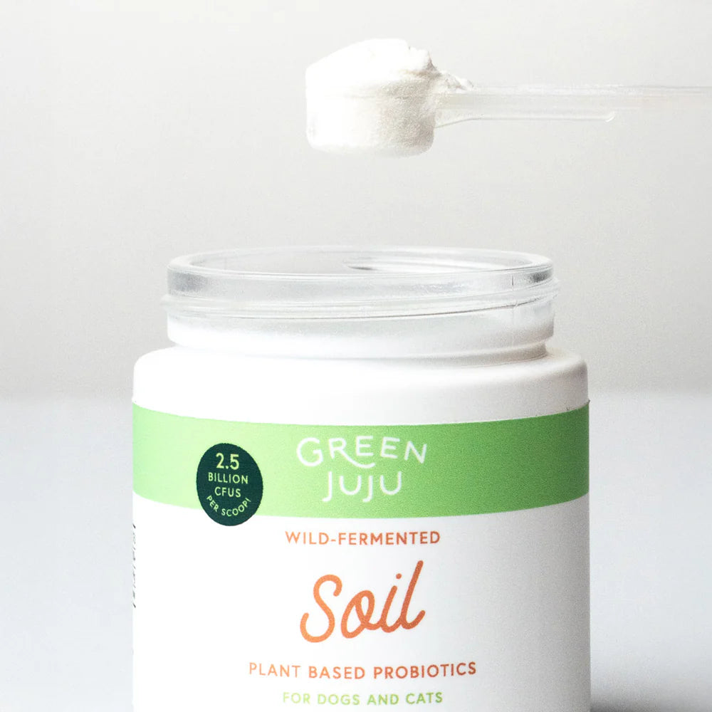 Soil - Plant Based Probiotics by Green Juju for Dogs and cats in a 30g jar on display with powder