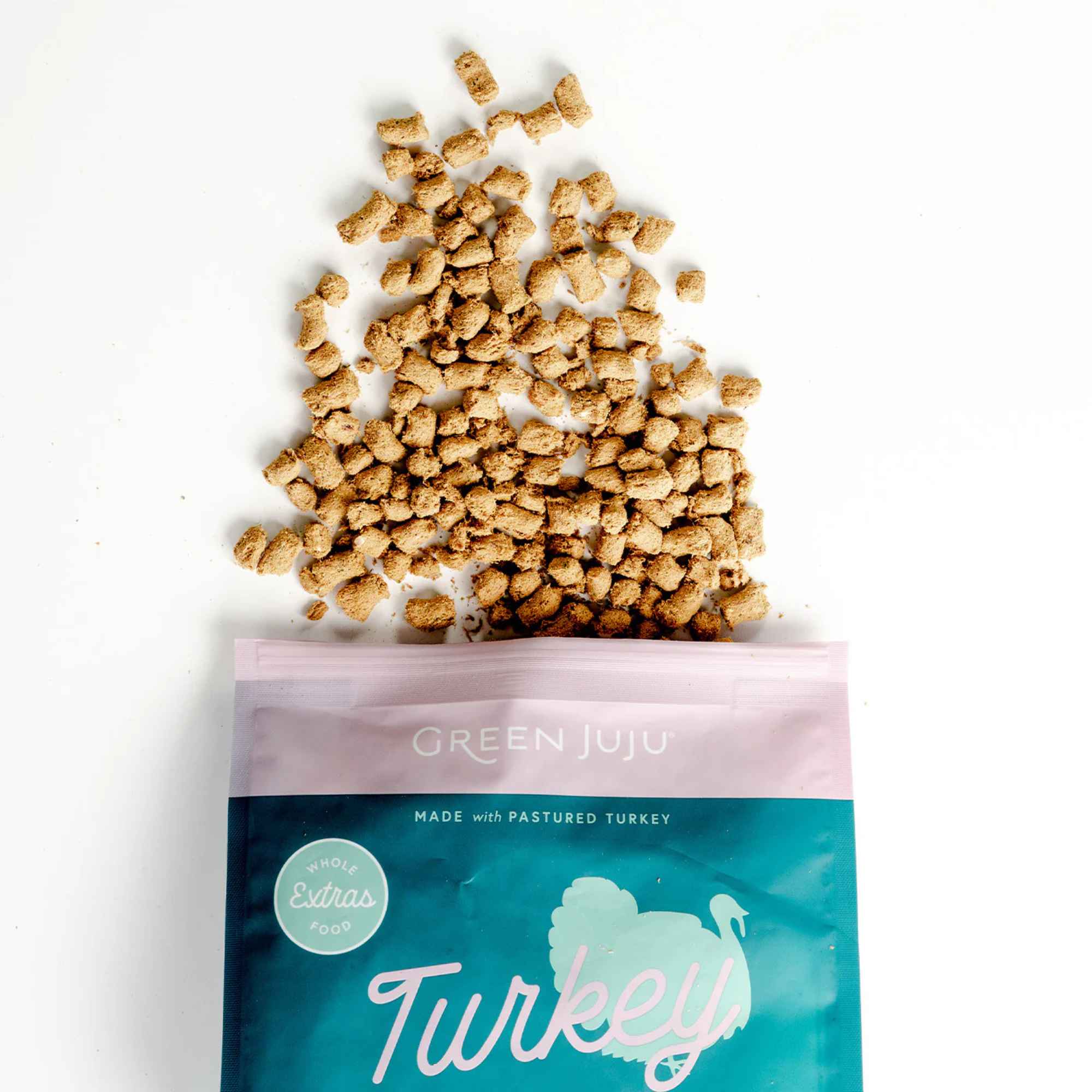 Green Juju turkey &amp; sardine recipe pet food packaging with spilled food on a white background